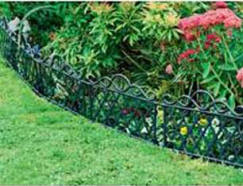Short decoratve railings separate bed and lawn